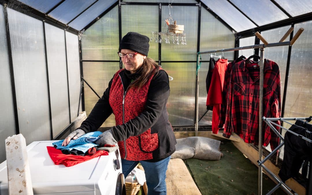 Tricia in the greenhouse as a makeshift laundry post flood